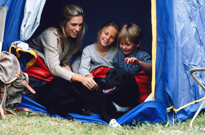 family in tent with dog